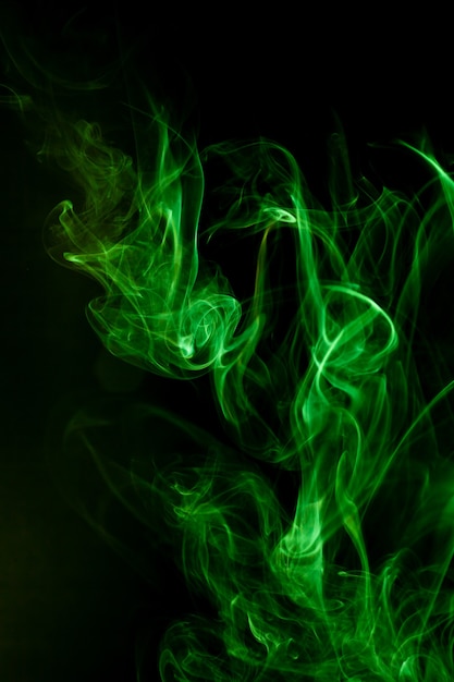 Green smoke motion on black background.