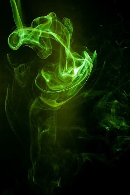 Green smoke motion on black surface.