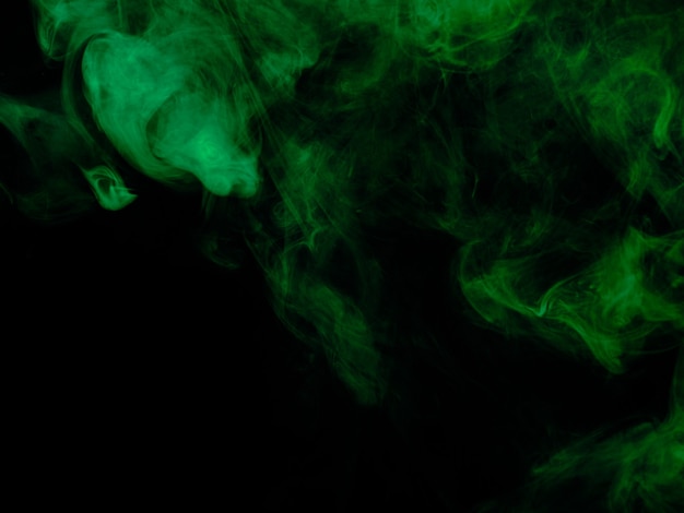 Green smoke texture on black background