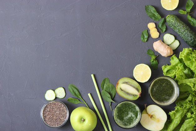 Green smoothie and fresh vegetables on the table for the detox organism