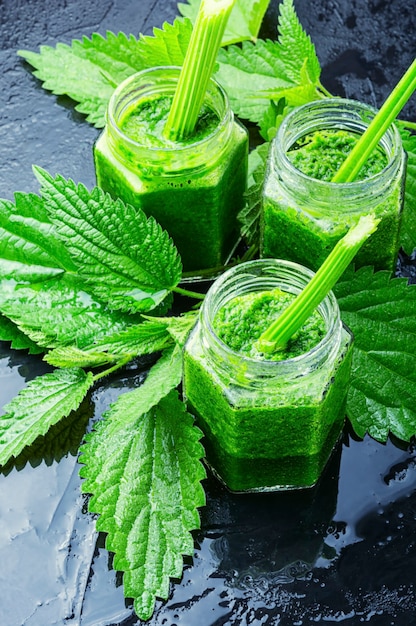 Green smoothie from nettle leaves in glass jars.Detox juices