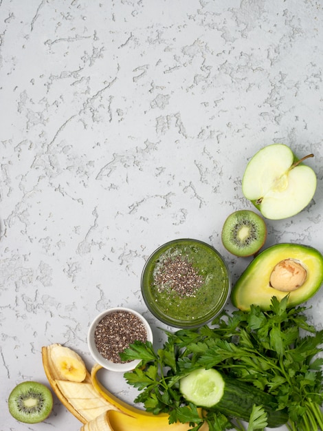 green smoothie in glass with fruits