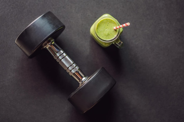 green smoothies and dumbbells in the gym