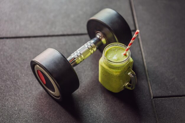 green smoothies and dumbbells in the gym