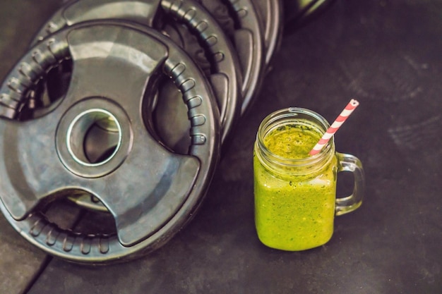green smoothies and dumbbells in the gym