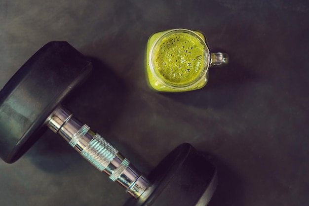 green smoothies and dumbbells in the gym