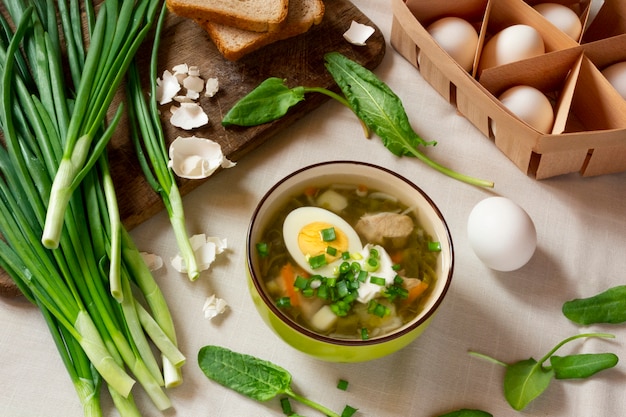 Green sorrel soup with egg and sour cream