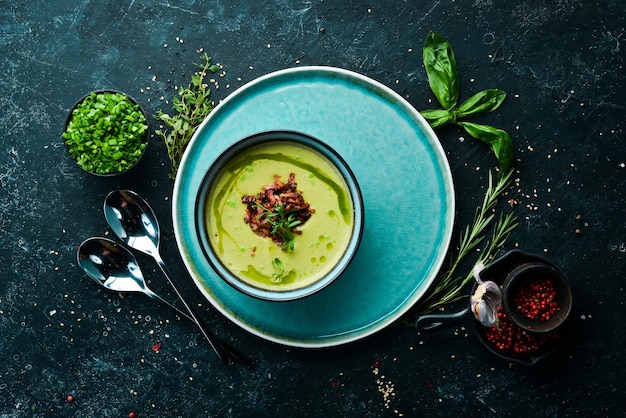 Green soup with bacon Soup with broccoli spinach and green peas Top view Rustic style