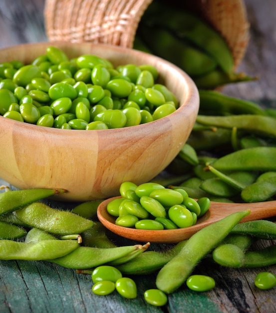 green soy beans in the wood bowl on table