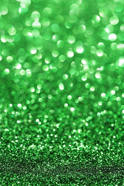 Green sparkle. Glitter background. Holiday blurred background