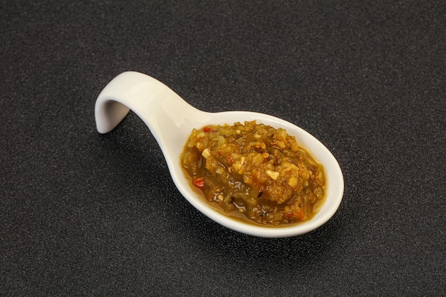 Green spicy sauce with pepper in the bowl