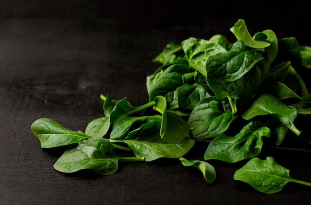 Green spinach on black background