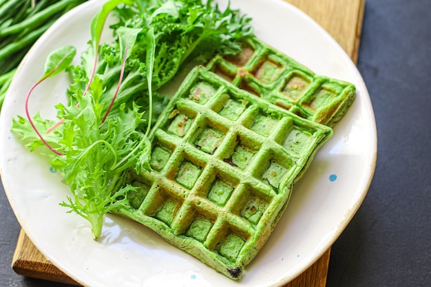 Green spinach waffles with greens and beans