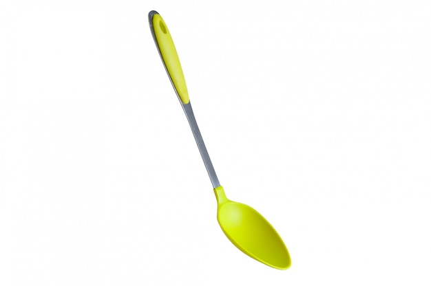 Green spoon on a white background, bright cutlery