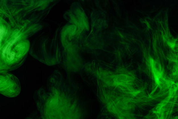 Green steam on a black background. Copy space.