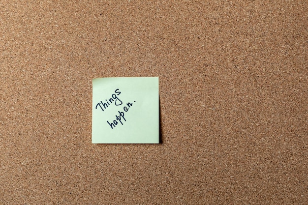 Green sticker on brown table. color sticker, motivational, quote, and words, note, message things happen.