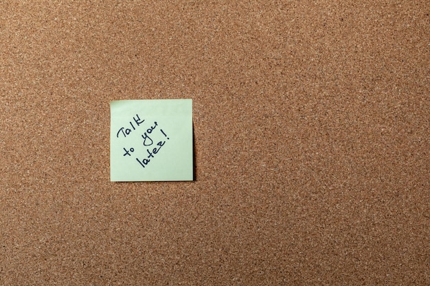 Green sticker on brown table. color sticker, motivational, quote and words, note, message