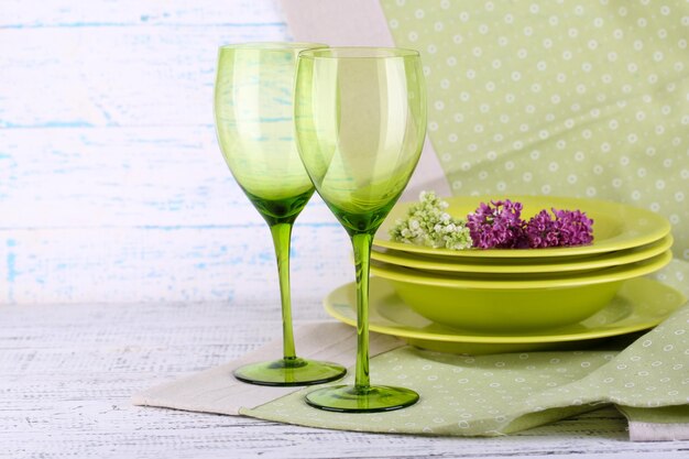 Green table settings on table on light background