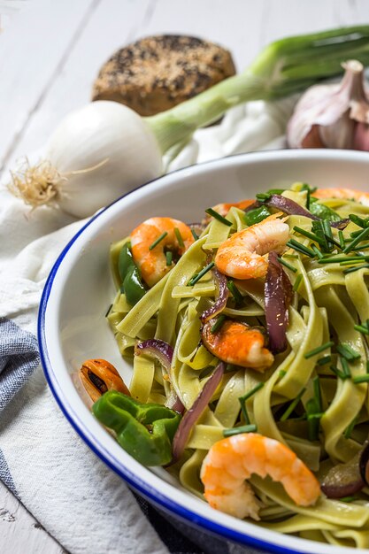 Green tagliatelle with seafood. Mussels; Prawns