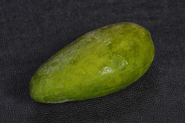 Green tasty mango over wooden background