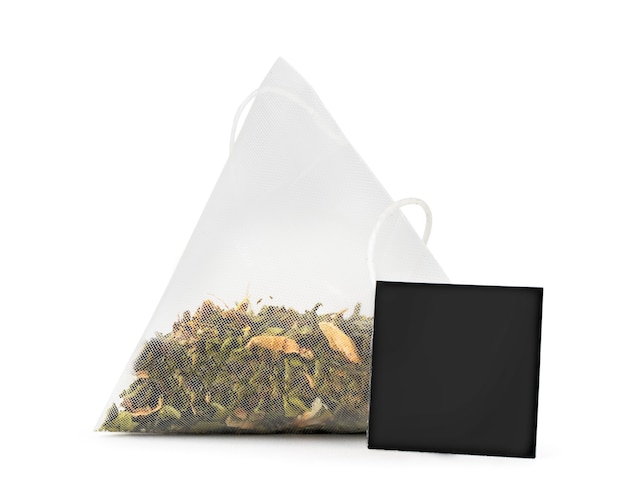 Photo green tea bag with tag close-up on white