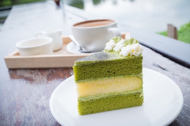 屋外レストランでのコーヒーの朝食と抹茶ケーキ