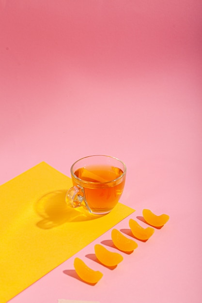 Green tea in a cup on a pink background