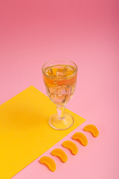 Green tea in a glass on a pink background