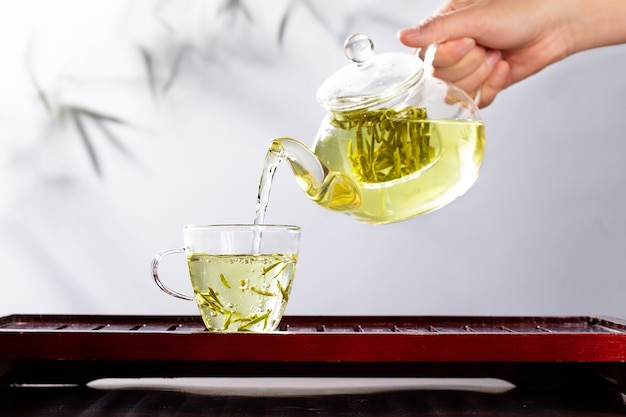 Фото Зеленый чай в стеклянном чайнике и чашке