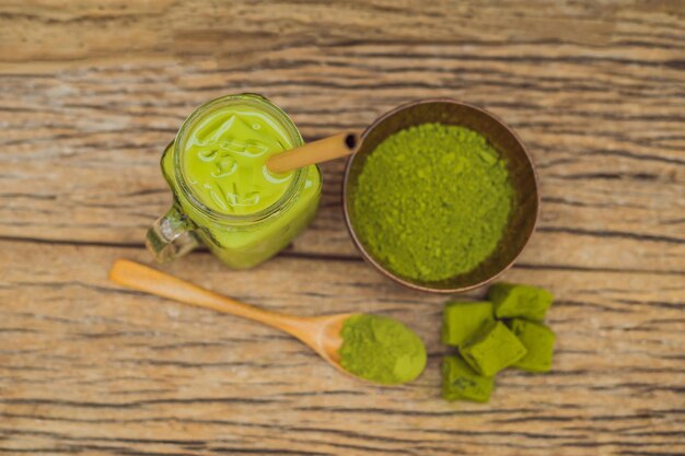 https://img.freepik.com/premium-photo/green-tea-latte-with-ice-mason-jar-matcha-powder-candy-made-matcha-wooden-background-homemade-iced-matcha-latte-tea-with-milk-zero-waste_247622-19199.jpg?size=626&ext=jpg