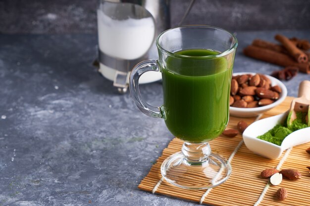 Green tea Matcha in glass on gray stone table