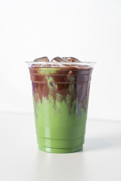 Green tea matcha latte with chocolate in glass