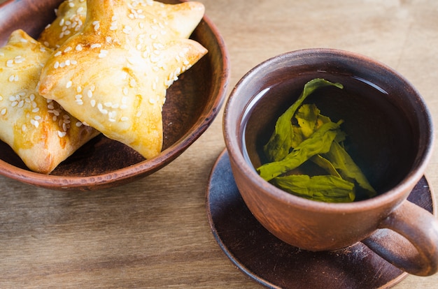 Green tea and pies on rustic wooden table