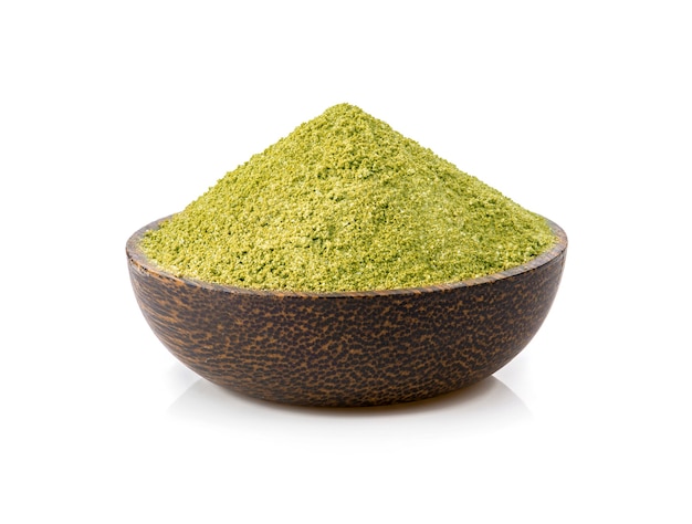 Green tea powder in bowl on white background