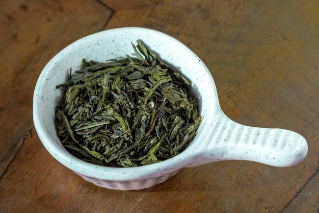 Green tea  in a white bowl on the wood table