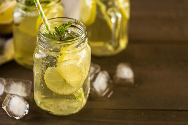 Green tea with citrus in drinking mason jar with ice.