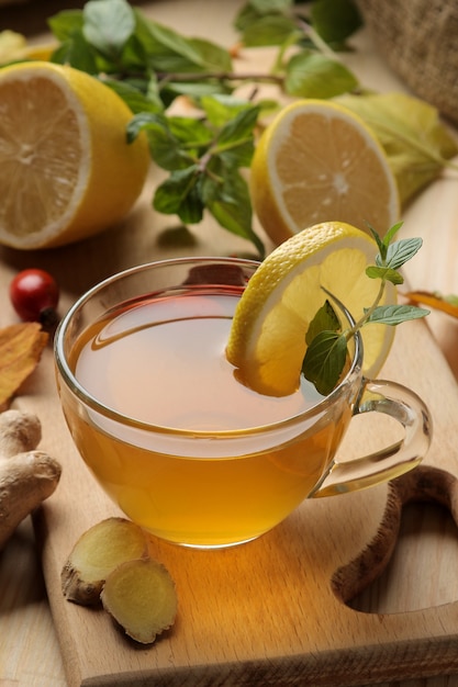 Green tea with lemon and cinnamon in a glass cup