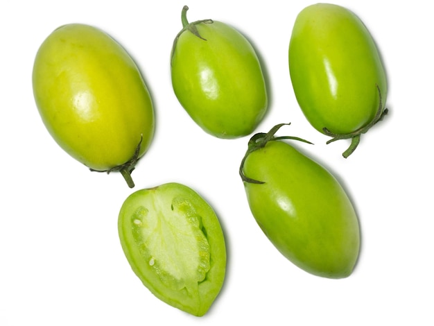  바탕에 있는 초록색 토마토: 미숙한 채소의 개념: 소금 준비: 소금 제품: 건강한 음식: 텍스트를 쓰기 위한 장소: 덤불에서 뽑은 미숙한 과일.