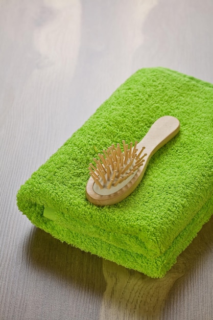 Green towel with hairbrush