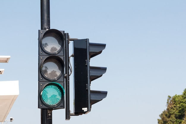 Green traffic light ,isolated on sky