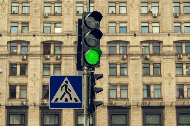 Green traffic light regulating the movement of pedestrians and\
vehicles