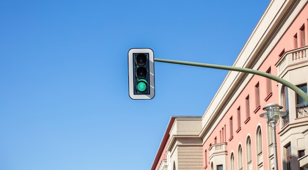 Green traffic lights for cars blue sky background