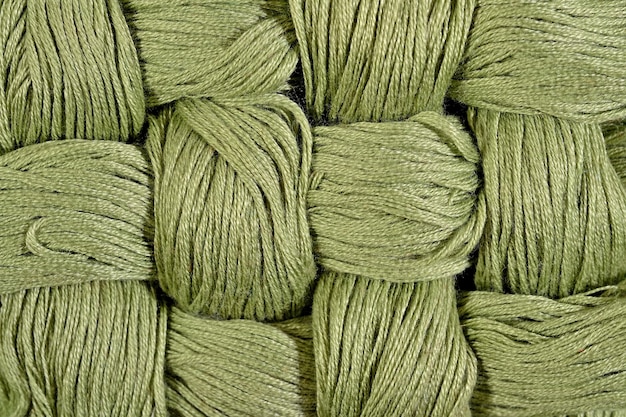 Green twisted skeins of floss as background texture