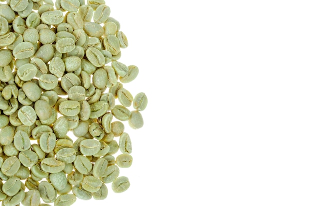 Green unroasted coffee beans on white wall