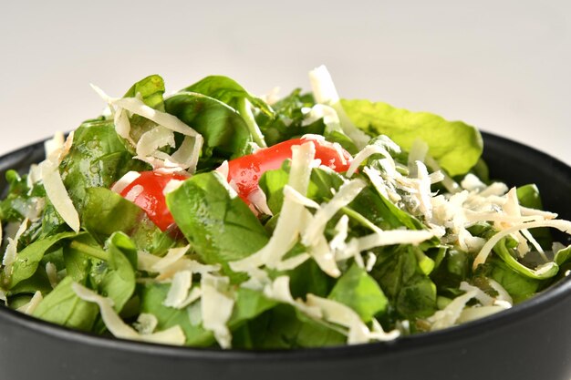 Green vegan salad from green leaves mix and vegetables.