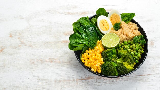 Green vegetable bowl Buddha quinoa green peas corn spinach broccoli egg Healthy food Top view Free space for your text