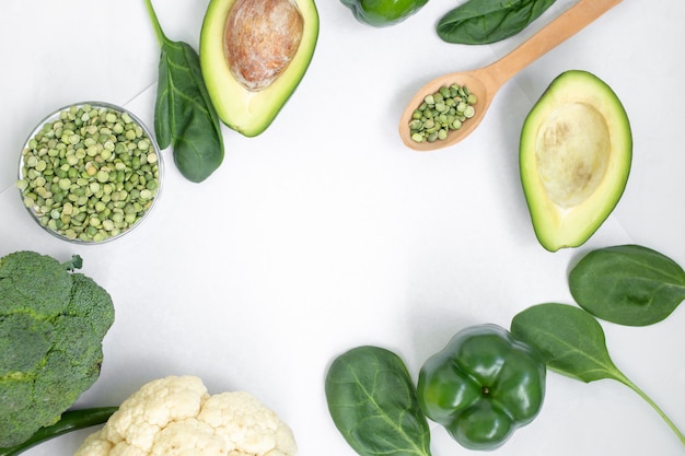 Green vegetables and herbs on a light background