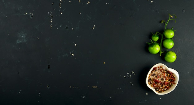 Photo green vegetables and spices on dark surface