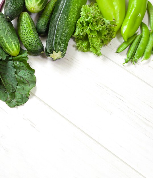 green vegetables on white wooden table with copy space