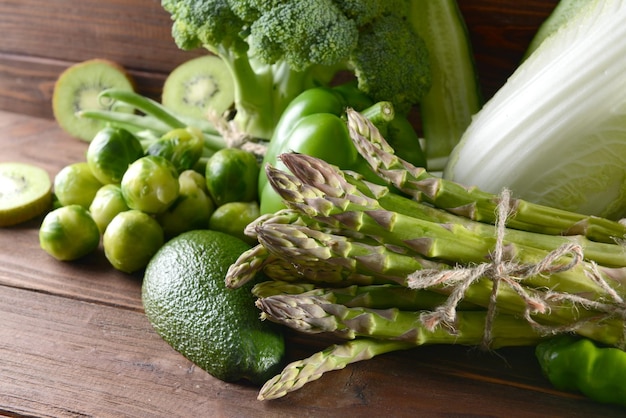 Green vegetables on wooden background